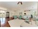 Open-concept living room with hardwood floors, comfortable seating, and views of the kitchen and dining area at 322 Langholm Dr, Venice, FL 34293