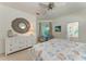 Bright main bedroom featuring a decorative mirror, dresser and outdoor access at 322 Langholm Dr, Venice, FL 34293