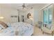 Bright main bedroom has a ceiling fan, access to a patio, and comfortable seating at 322 Langholm Dr, Venice, FL 34293