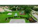 Lovely community playground featuring a playground set and a basketball court surrounded by lush trees and green space at 322 Langholm Dr, Venice, FL 34293
