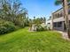 Expansive backyard offers a mix of green lawn and mature trees, perfect for relaxation and recreation at 323 Timberlake Dr # 323, Bradenton, FL 34210
