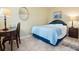 Cozy bedroom with tile flooring, featuring a desk and nightstand with a lamp at 323 Timberlake Dr # 323, Bradenton, FL 34210