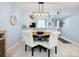 Charming dining area with a round table, upholstered chairs, and a modern lighting fixture at 323 Timberlake Dr # 323, Bradenton, FL 34210