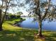 Relaxing lake view with mature trees and lush green grass at 323 Timberlake Dr # 323, Bradenton, FL 34210