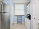 Efficient laundry area with stackable washer and dryer next to a stainless steel refrigerator at 323 Timberlake Dr # 323, Bradenton, FL 34210
