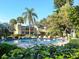 Community pool surrounded by tropical landscaping and lounge chairs at 323 Timberlake Dr # 323, Bradenton, FL 34210