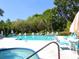 Relax in this community pool and hot tub with comfortable lounge chairs and tables at 323 Timberlake Dr # 323, Bradenton, FL 34210