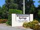 Community sign for Wildewood Springs, set amidst lush landscaping, creating a welcoming entrance at 323 Timberlake Dr # 323, Bradenton, FL 34210