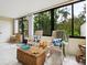 Bright sunroom with tile floors, rocking chairs, and beautiful views of the lush greenery at 323 Timberlake Dr # 323, Bradenton, FL 34210