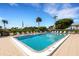 Inviting outdoor pool area with comfortable lounge chairs and lush tropical landscaping at 3235 Gulf Of Mexico Dr # A305, Longboat Key, FL 34228
