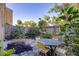 Private backyard oasis with a dining table surrounded by lush landscaping at 3457 Clark Rd # 156, Sarasota, FL 34231