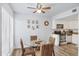 Cozy dining area featuring a glass table, wicker chairs, and a modern ceiling fan at 3457 Clark Rd # 156, Sarasota, FL 34231