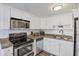 Updated kitchen featuring granite counters, white cabinets, stainless appliances, and ample storage at 3457 Clark Rd # 156, Sarasota, FL 34231