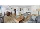 Inviting living room featuring wood floors, dining area, and a view of the kitchen at 3457 Clark Rd # 156, Sarasota, FL 34231