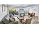 Comfortable living room with wood floors, patio access, and an adjacent dining area at 3457 Clark Rd # 156, Sarasota, FL 34231