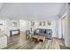 Bright and airy living room with wood floors, a modern sofa, and patio access at 3457 Clark Rd # 156, Sarasota, FL 34231