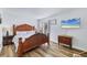 Spacious main bedroom with a statement headboard and wood-style flooring at 3457 Clark Rd # 156, Sarasota, FL 34231