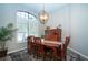 Elegant dining room features an ornate light fixture, large windows with shutters, and a stylish rug at 349 Blackbird Ct, Bradenton, FL 34212