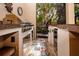 Outdoor grill area featuring a stainless steel grill, under-counter refrigerator, and floral rug at 349 Blackbird Ct, Bradenton, FL 34212