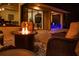 Relaxing outdoor patio area featuring a fire pit, comfortable seating, and an attached covered area at 349 Blackbird Ct, Bradenton, FL 34212