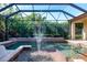 The pristine screened-in pool boasts a water fountain and well-manicured landscaping at 349 Blackbird Ct, Bradenton, FL 34212