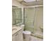 Bathroom showcasing a shower with glass doors, toilet, and vanity with sink at 3500 El Conquistador Pkwy # 129, Bradenton, FL 34210
