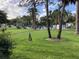 Large community pool surrounded by ample green space and mature trees at 3500 El Conquistador Pkwy # 129, Bradenton, FL 34210