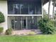 Exterior of home with sliding glass doors leading from a Florida room to a brick patio at 3500 El Conquistador Pkwy # 129, Bradenton, FL 34210