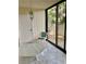 Enclosed lanai with tile floors, glass sliding doors, and outdoor access at 3500 El Conquistador Pkwy # 129, Bradenton, FL 34210