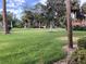 Well manicured green space in the community with a variety of trees and lush grass at 3500 El Conquistador Pkwy # 129, Bradenton, FL 34210