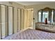 Bedroom features multiple large closets and a vanity with a 3-pane mirror at 3500 El Conquistador Pkwy # 129, Bradenton, FL 34210