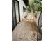 Private outdoor patio with tiled floor and a lush garden view at 3500 El Conquistador Pkwy # 129, Bradenton, FL 34210