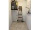Utility area featuring water heater, tile flooring, and shelving for efficient home maintenance at 3500 El Conquistador Pkwy # 129, Bradenton, FL 34210