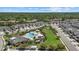 Aerial view of townhomes with a beautiful community pool and a lush green park area at 3664 Course Dr, Sarasota, FL 34232