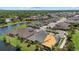Expansive aerial shot showcasing homes nestled around a lake, illustrating community living at 3664 Course Dr, Sarasota, FL 34232