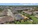 Broad aerial perspective featuring a community with a central lake, highlighting the residential layout at 3664 Course Dr, Sarasota, FL 34232