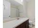 Bathroom featuring dark wood vanity, solid surface counters, and a shower at 3664 Course Dr, Sarasota, FL 34232