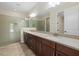 Spacious bathroom featuring a double vanity, a glass-enclosed shower, and elegant neutral finishes at 3664 Course Dr, Sarasota, FL 34232