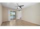 Bright bedroom with water view and wood-look floors and ceiling fan at 3664 Course Dr, Sarasota, FL 34232