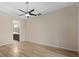 Spacious bedroom featuring wood-look floors, ceiling fan, and ensuite bathroom entrance at 3664 Course Dr, Sarasota, FL 34232