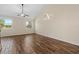 Bright, airy bedroom with wood-look flooring, a ceiling fan, and scenic outdoor views through two windows at 3664 Course Dr, Sarasota, FL 34232