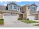 Charming townhome featuring a two-car garage, well-maintained lawn, and a beautifully designed front entrance at 3664 Course Dr, Sarasota, FL 34232