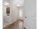 Welcoming hallway features wood-look flooring, leading to the laundry room and a bright, airy interior at 3664 Course Dr, Sarasota, FL 34232