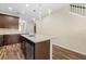 Kitchen boasts an island with a sink, quartz countertops, dark wood cabinets and stainless steel dishwasher at 3664 Course Dr, Sarasota, FL 34232