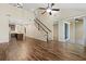Spacious living area featuring tile floors, a staircase, sliding glass doors and an open flow to the kitchen at 3664 Course Dr, Sarasota, FL 34232