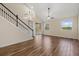 Open-concept living area with wood-look flooring, a staircase, and sliding glass doors for access to the outdoors at 3664 Course Dr, Sarasota, FL 34232