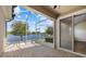 Relaxing screened lanai featuring brick pavers, providing stunning views of the adjacent lake at 3664 Course Dr, Sarasota, FL 34232