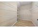 Walk-in closet featuring ample shelving and wood-look floors at 3664 Course Dr, Sarasota, FL 34232