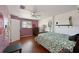 Bedroom featuring wood floors, ceiling fan, stop sign decor and natural lighting at 404 62Nd Nw St, Bradenton, FL 34209