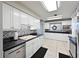 Bright kitchen with white cabinets, modern backsplash, and tile flooring at 404 62Nd Nw St, Bradenton, FL 34209